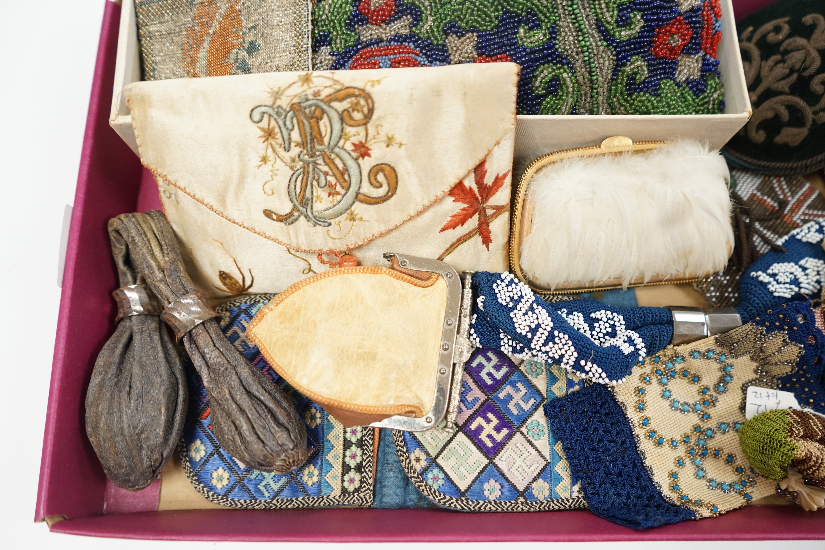 A velvet and metal embroidered reticule possibly 18th century, together with a collection of beaded embroidered knitted and leather purses, bags misers purses and a feather coin purse(14)